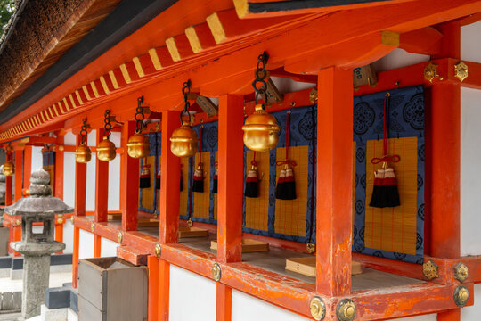 A vibrant view of Fushimi Inari Shrine, in Kyoto, Japan's famous shrine dedicated to Inari, the god of rice. The Senbon Torii gates lead to this area with hanging bells. - Powered by Adobe