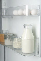 Different dairy products and eggs in fridge, closeup
