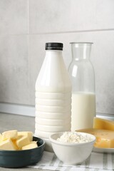 Different dairy products on table in kitchen, closeup