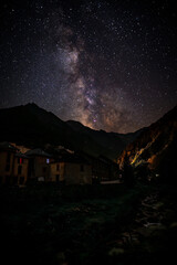The Milky Way above a mountain village in the Pyrenees mountain