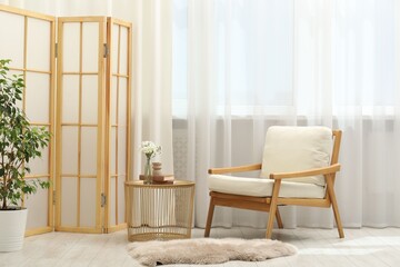 Stylish furniture near window with curtains in living room. Interior design