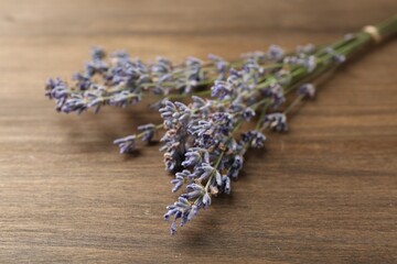 Aromatic lavender flowers on wooden table, closeup