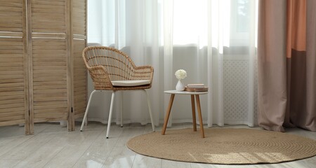 Stylish furniture near window with curtains in living room. Interior design