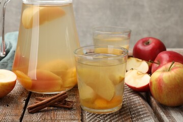 Tasty compot with apples on wooden table, closeup