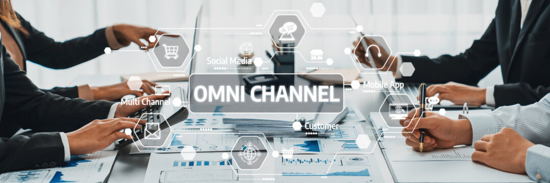 A dynamic business meeting showcasing professionals collaborating on omni channel strategies using technology tools to enhance data analysis and improve customer engagement. Amity