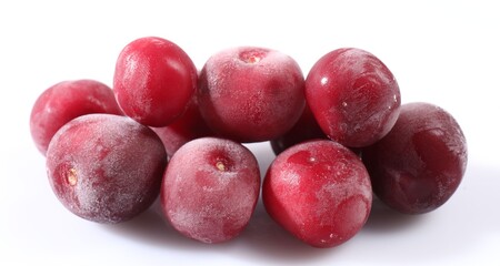 Pile of ripe frozen cherries on white background, closeup