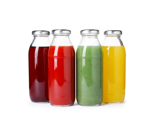 Tasty juices in glass bottles isolated on white