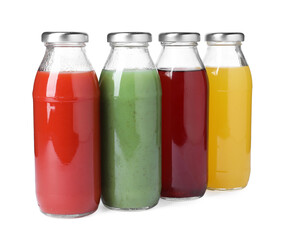 Tasty juices in glass bottles isolated on white