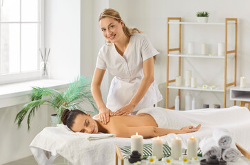 Massage female therapist doing relaxing aromatics massage oil pleasure, stimulating skin health,...