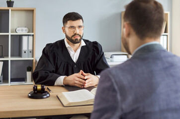 Judge, law professional solicitor or barrister, attorney in court of law talking to client, accuse...