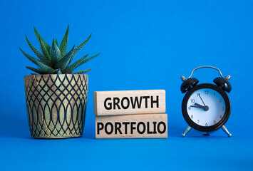 Growth Portfolio symbol. Concept word Growth Portfolio on wooden blocks. Beautiful blue background...