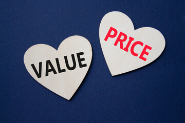 Price and Value symbol. Concept word Price and Value on wooden hearts. Beautiful deep blue...