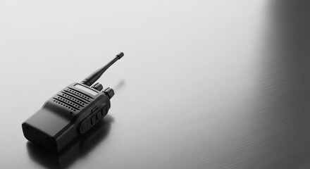 Black two way radio or walkie talkie on a metal surface. Military communication device concept for tactical planning.