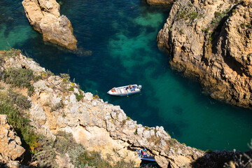 Boat in the Algarves surrounded by cliffs