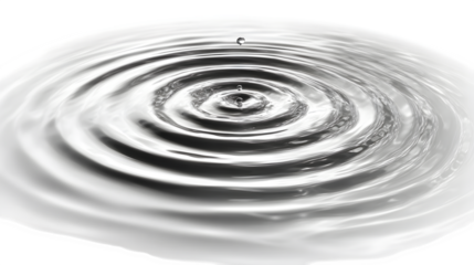 A single drop of water creates expanding ripples across a calm, reflective surface, symbolizing impact and change.