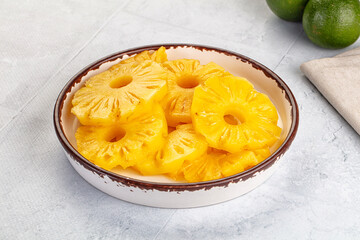 Sweet canned pineapple slices in syrope