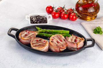 Tasty grilled pork medallion with bacon