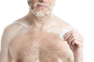 Exotic albino man holding a condom wrapper packet, copy space, white background. Safe sex protection contraceptive, sexual health, intimate adult couple games concep
