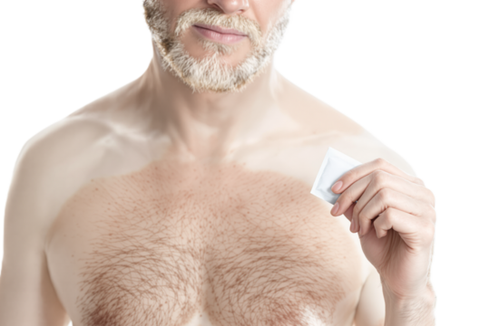 Exotic albino man holding a condom wrapper packet, copy space, white background. Safe sex protection contraceptive, sexual health, intimate adult couple games concep - Powered by Adobe