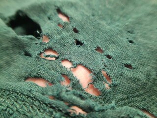 closeup there is so many hole on the broken old green bamboo cotton clothes texture