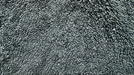 close up of dark gray fleece textile with soft wavy texture for cozy fabric background or modern...