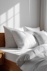 Sunlit white bedding in minimalist bedroom with wooden accents