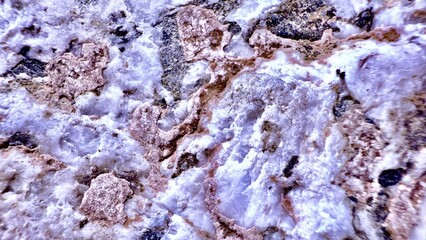rough quartz and feldspar mineral surface with pink and white crystal formations perfect for abstract texture or stone background