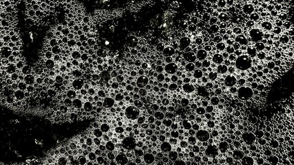 abstract black and white soap bubble cluster with reflective texture for modern background or creative design surface