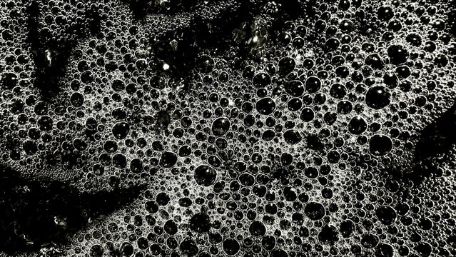 abstract black and white soap bubble cluster with reflective texture for modern background or creative design surface