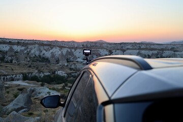 Car sunset hills. sunset reflection on car High quality photo