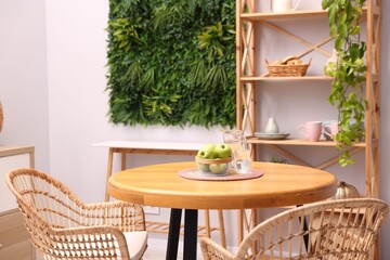 Wooden table with chairs and decor in stylish dining room. Interior design
