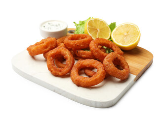 Fried squid rings, lemon, lettuce and sauce isolated on white