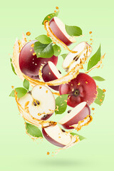 Bright apple juice with splashes, ripe red apples with green leaves levitated as swirl, on  pastel green background. Summer refreshing fruits, drink for advertising, label product, poster, card.