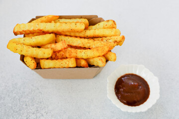 Crispy french fries served with dipping sauce in a casual setting
