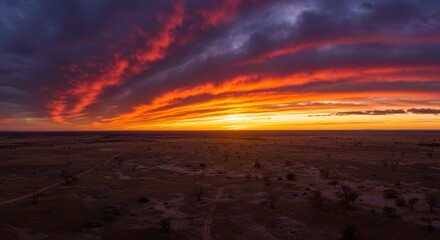 Obraz premium Spectacular sunset painting the flat landscape with vibrant colors and dramatic cloudscape