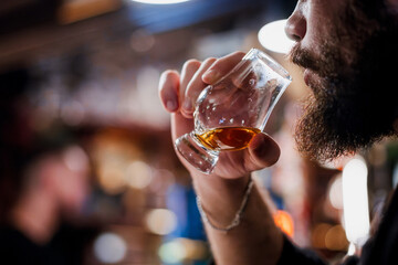 Person holding a whisky glass