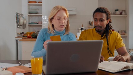 Couple managing domestic bills and online shopping at home