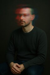 Blurred portrait of pensive young caucasian male with a contemplative expression