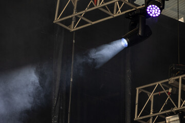 Stage spotlight illuminating smoke in dark theater