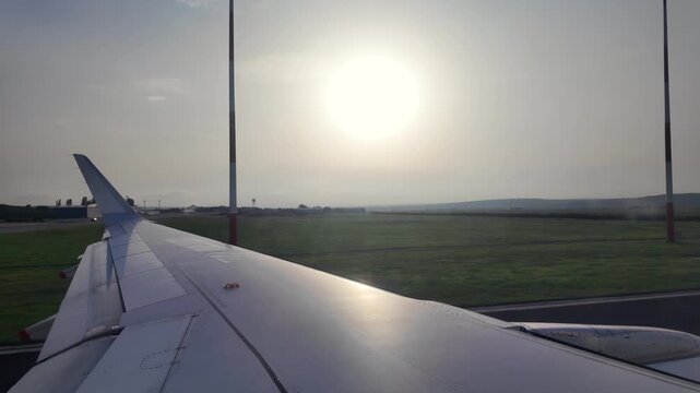 View of the airplane wing from window seat moving through the Chisinau International Airport