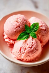 Three scoops of creamy strawberry ice cream placed in a simple bowl, beautifully garnished with a sprig of fresh basil. A delightful treat on a sunny day