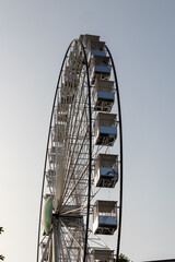 Ferris wheel standing tall against a clear sky in amusement park