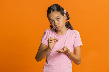 Need some more, please give me. Young preteen child girl kid showing a little bit gesture with...