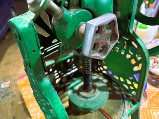 Traditional shaved ice machine with green paint.