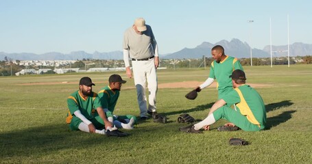 Entering coach greeting diverse teammates sitting on outfield grass, inspecting gloves and caps