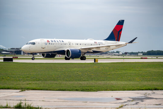 Milwaukee, WI, USA - August 13, 2025: Delta Airlines Airbus A220 taxies on the runway at Milwaukee General Mitchell International Airport.  