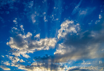 sunset clouds in blue sky with crepuscular rays