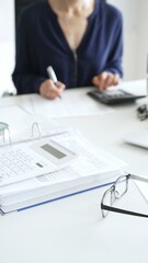 Professional analyzing financial data, writing notes near laptop, magnifying glass, documents,...