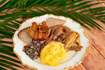 Traditional rustic Brazilian food, guinea fowl, Numida meleagris, with polenta, artisanal bread,...