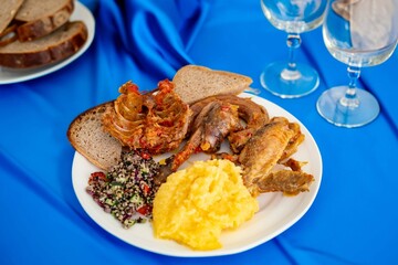 Traditional rustic Brazilian food, guinea fowl, Numida meleagris, with polenta, artisanal bread,...